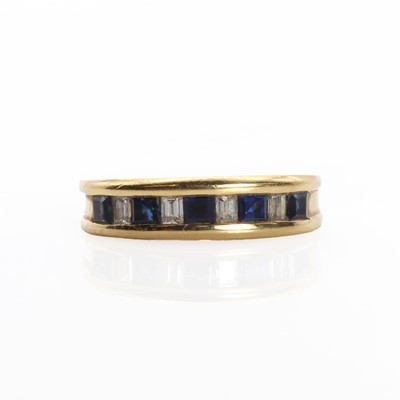 Lot 1163 - An 18ct gold sapphire and diamond half eternity ring