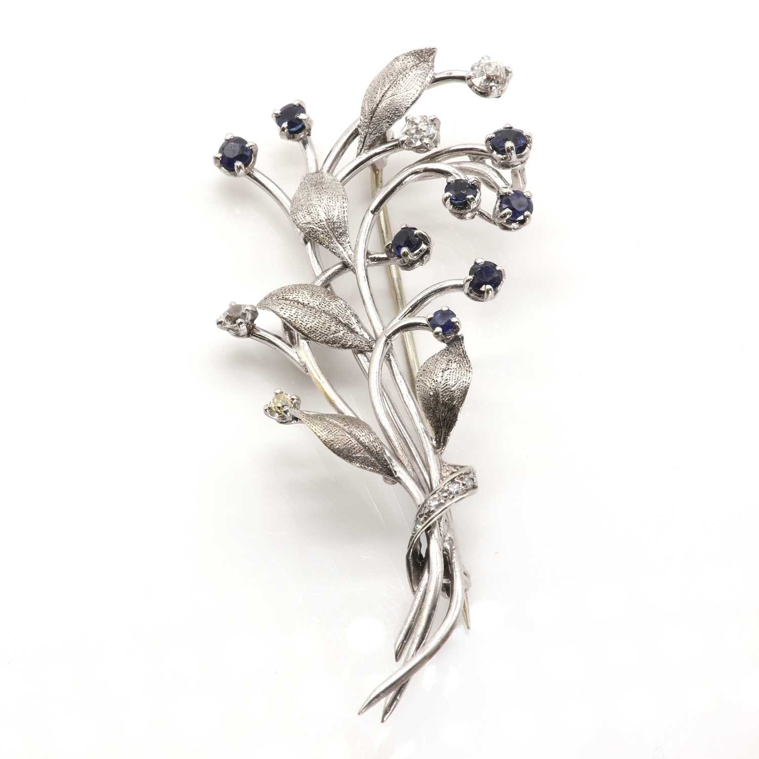 Lot 50 - A cased diamond and sapphire set spray brooch