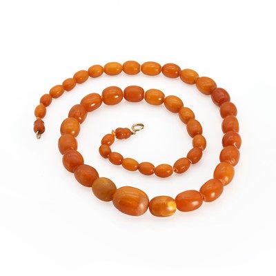 Lot 1207 - A single row graduated butterscotch amber and copal bead necklace