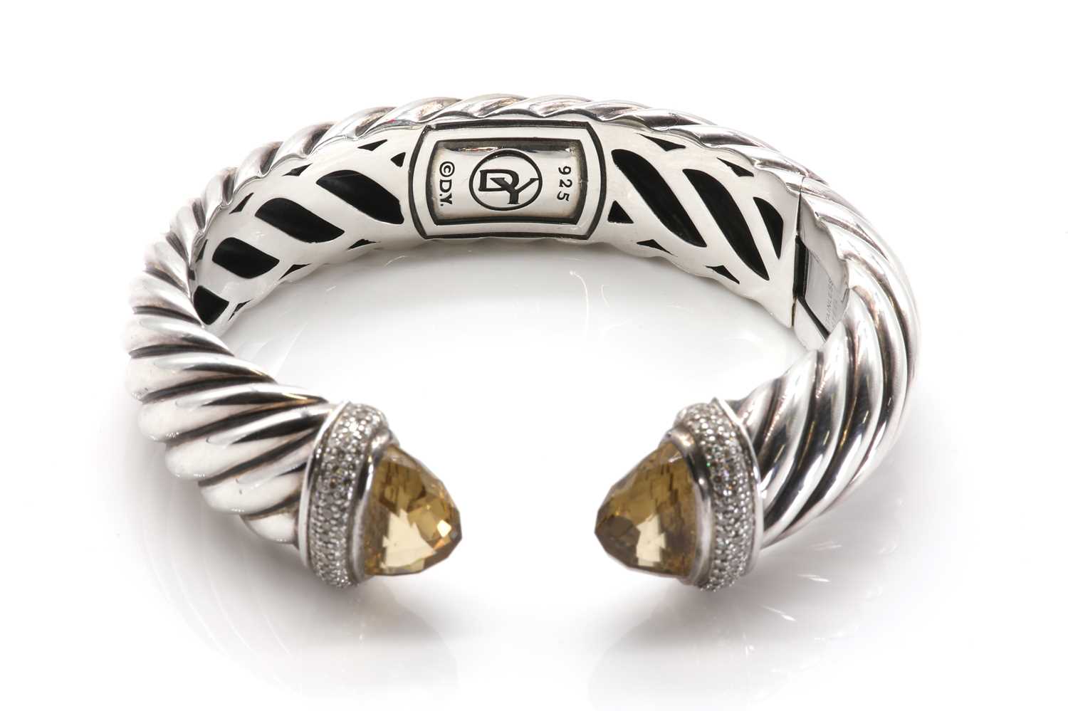 Lot 217 - A sterling silver diamond and citrine set hinged torque bangle, by David Yurman