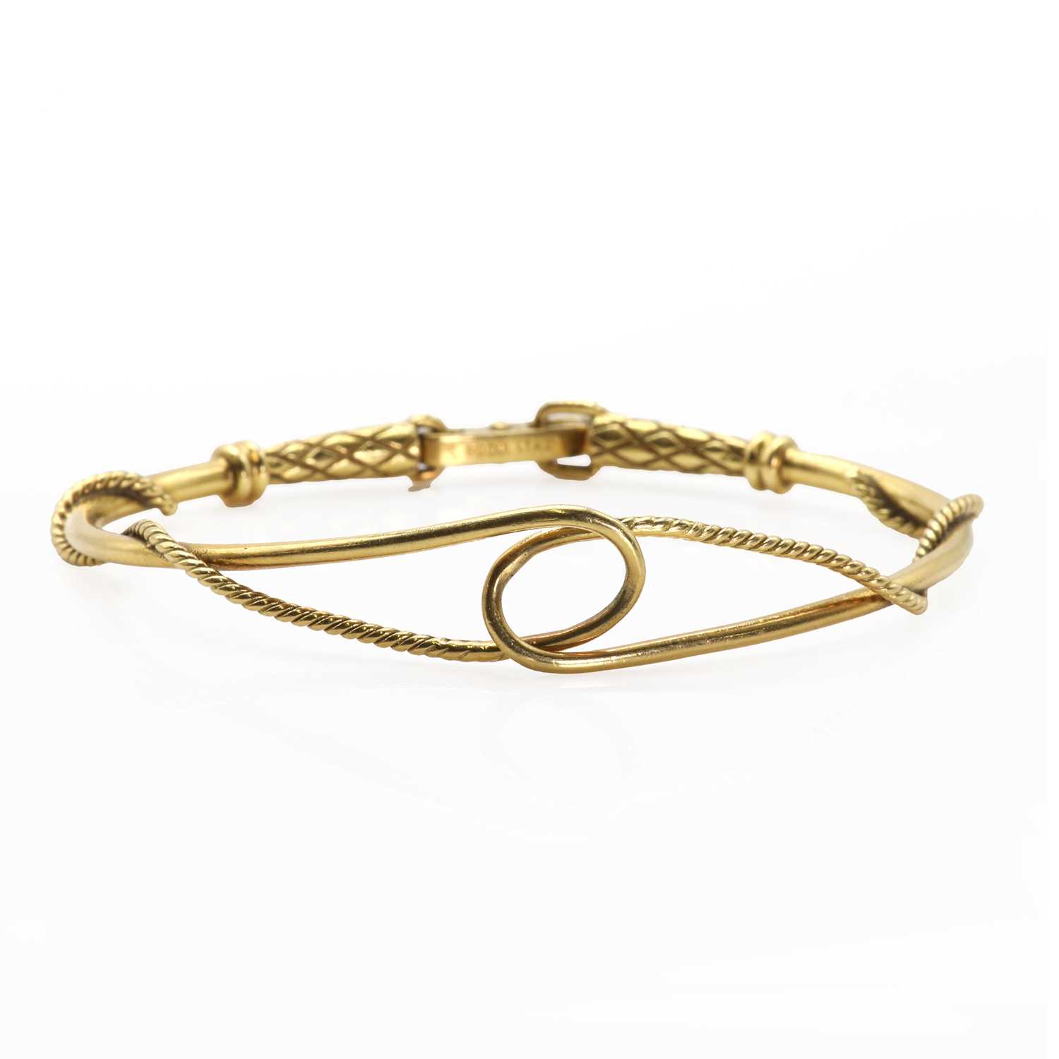 Lot 62 - An 18ct gold rope design articulated bangle,