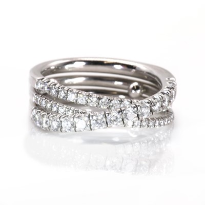 Lot 134 - An 18ct white gold 'Étincelle' three row diamond half eternity ring, by Cartier