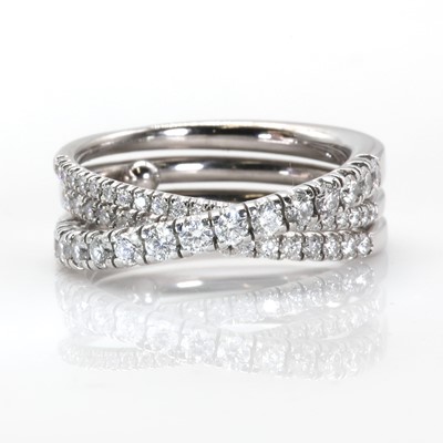 Lot 134 - An 18ct white gold 'Étincelle' three row diamond half eternity ring, by Cartier