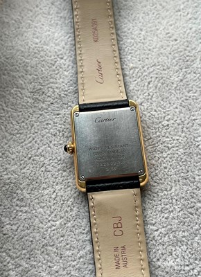 Lot 313 - A ladies' gold and stainless steel Cartier Tank Solo quartz strap watch