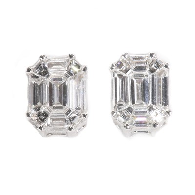 Lot 147 - A pair of white gold and diamond invisible set stud earrings