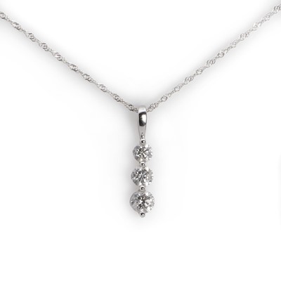 Lot 1060 - A three stone diamond pendant with chain