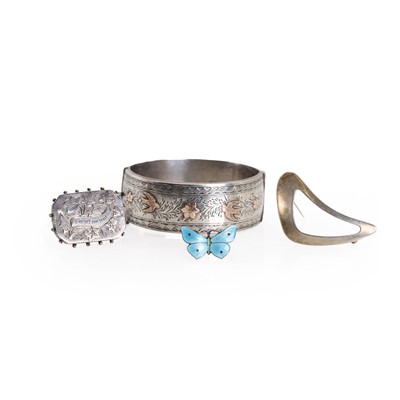 Lot 303 - Three silver brooches and a silver bangle