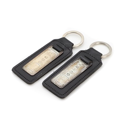 Lot 1455 - A Junghans wristwatch, a Dunhill lighter and two silver keyrings