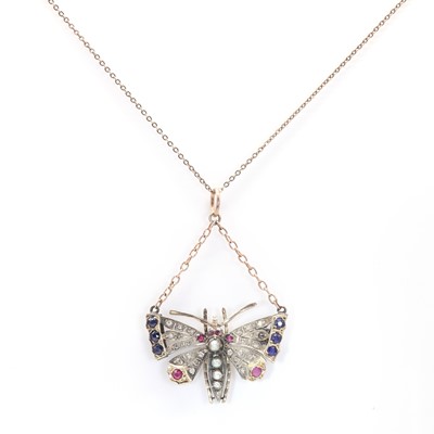 Lot 21 - A split pearl, ruby, sapphire and diamond butterfly pendant/brooch, c.1900