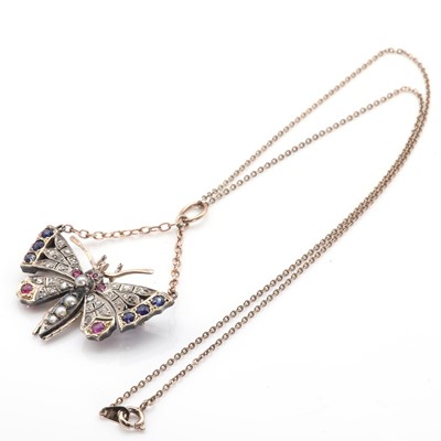 Lot 21 - A split pearl, ruby, sapphire and diamond butterfly pendant/brooch, c.1900