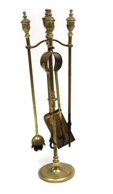Lot 378 - A set of brass fire tools and stand