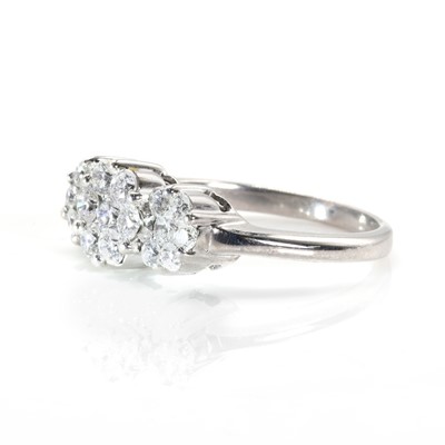 Lot 75 - A white gold diamond set triple floral cluster ring