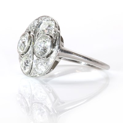 Lot 44 - A platinum and diamond circular plaque ring, c.1930