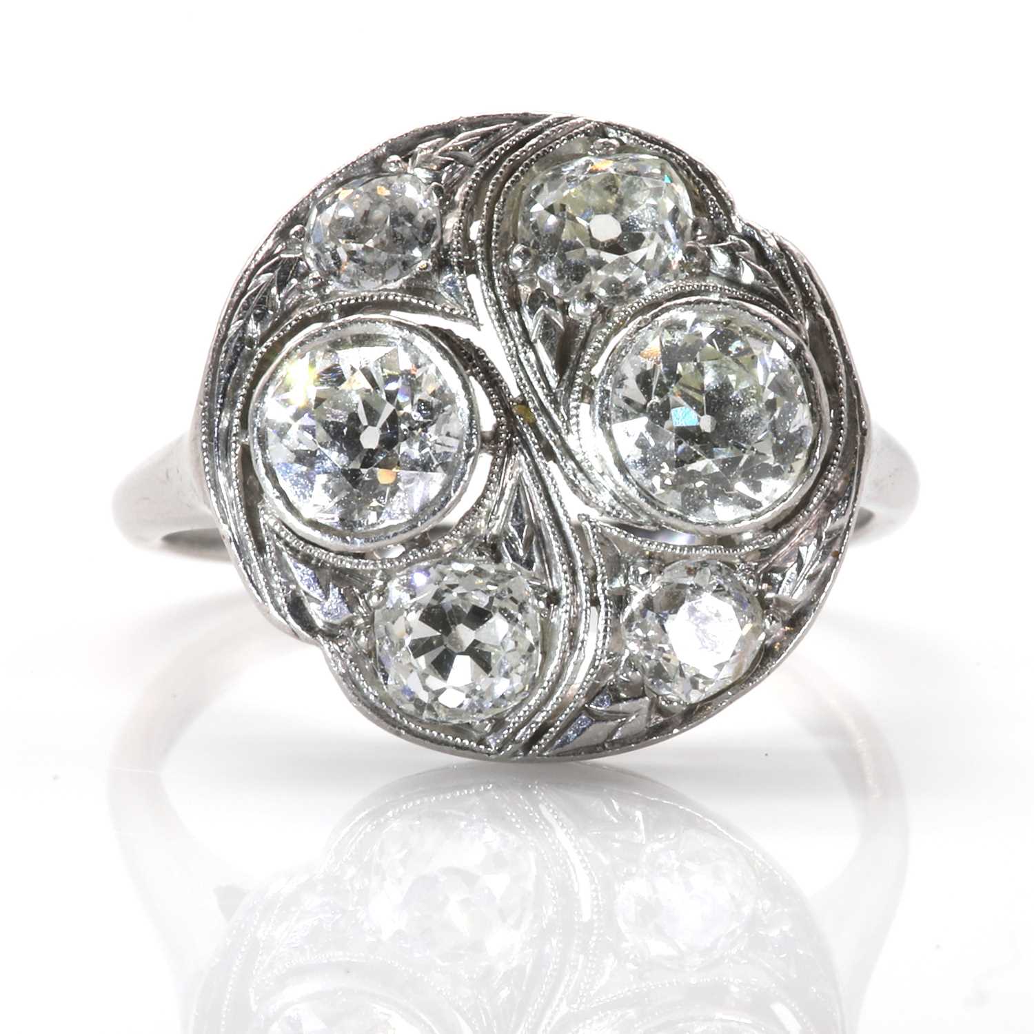 Lot 44 - A platinum and diamond circular plaque ring, c.1930