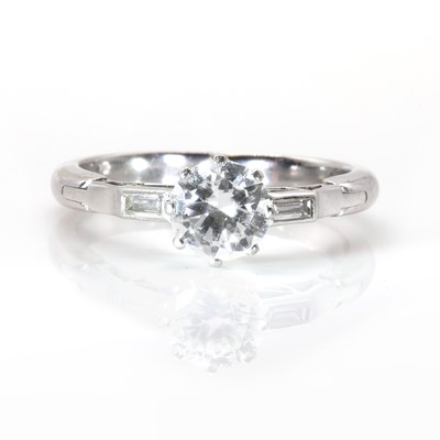 Lot 228 - A white gold brilliant cut diamond ring, with baguette cut diamond accents