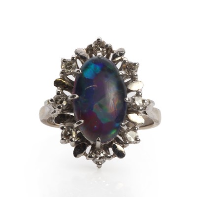 Lot 1192 - A white gold opal triplet and diamond cluster ring