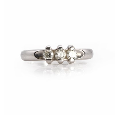Lot 1057 - A white gold three stone diamond ring