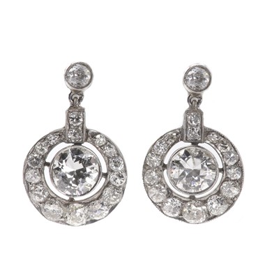 Lot 35 - A pair of graduated diamond set pendant earrings