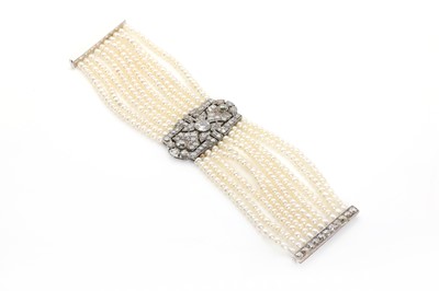 Lot 38 - An Art Deco cultured pearl bracelet with a diamond set plaque