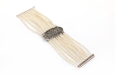 Lot 38 - An Art Deco cultured pearl bracelet with a diamond set plaque