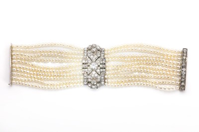 Lot 38 - An Art Deco cultured pearl bracelet with a diamond set plaque