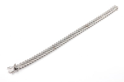 Lot 137 - An 18ct white gold leaf design link diamond line bracelet, by Asprey