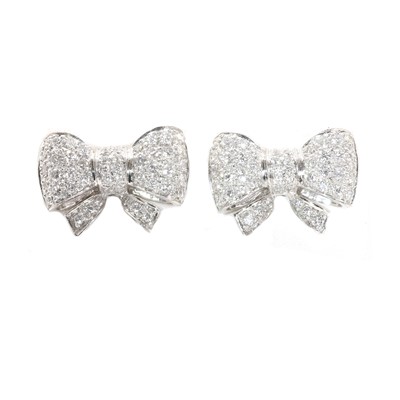 Lot 34 - A pair of platinum and diamond bow-style stud earrings