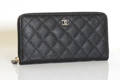 Lot 343 - A Chanel black grained calfskin zip around wallet