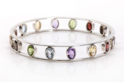 Lot 1177 - A silver multicolour gemset bangle