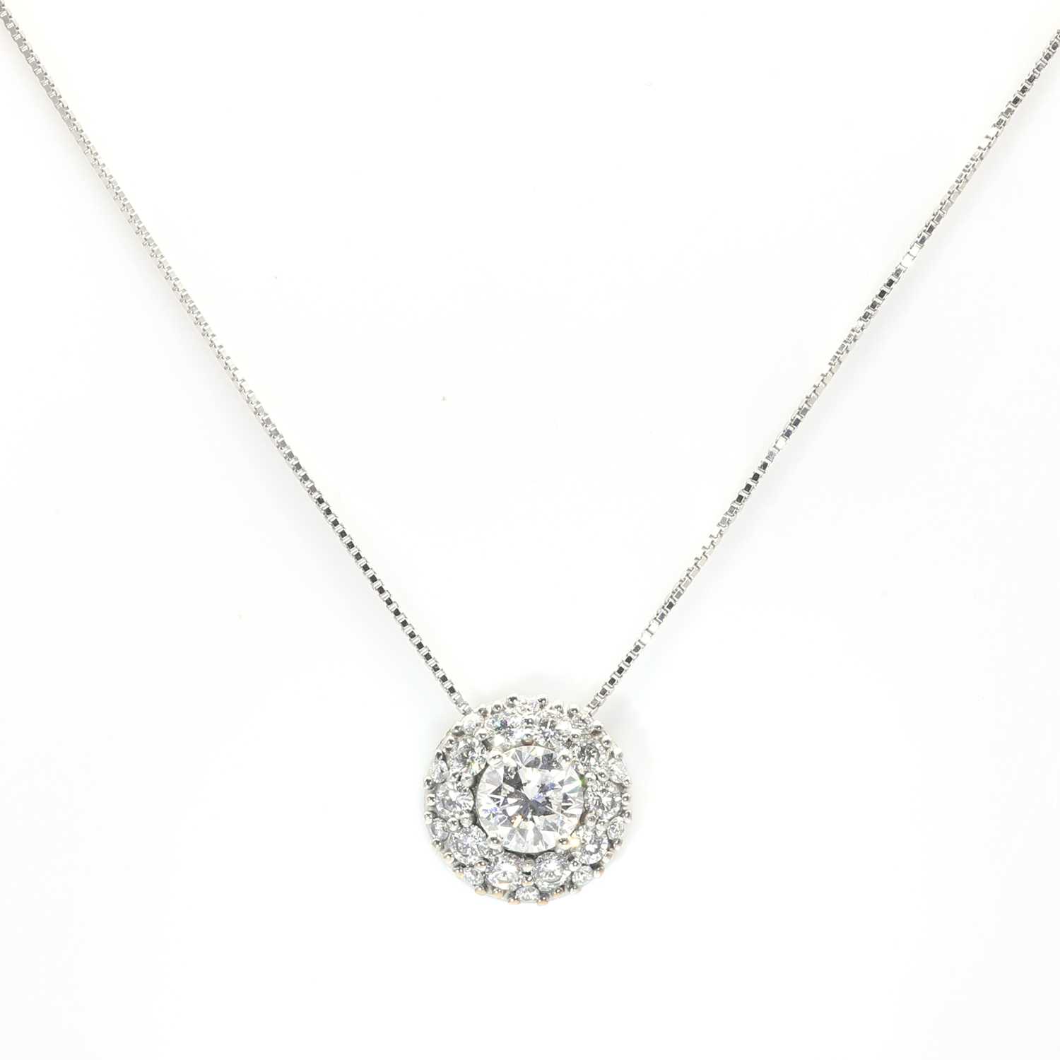 Lot 96 - A  white gold diamond set circular cluster pendant and chain