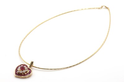 Lot 84 - A diamond and ruby heart pendant on a gas pipe circlet
