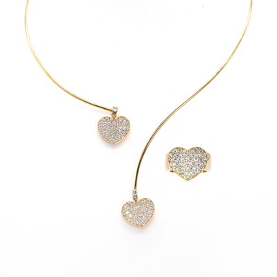 Lot 250 - A gold and diamond heart shaped ring and torque necklace suite