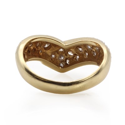 Lot 1059 - A gold diamond set wishbone ring