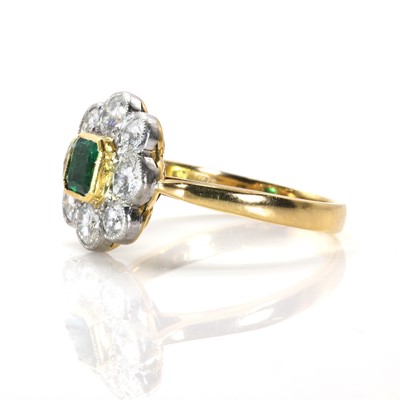 Lot 109 - An 18ct gold emerald and diamond daisy cluster ring