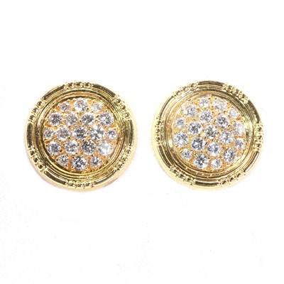 Lot 69 - A pair of gold diamond set disc shaped earrings by Garrard & Co., c.1990