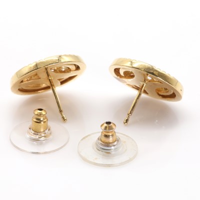 Lot 69 - A pair of gold diamond set disc shaped earrings by Garrard & Co., c.1990