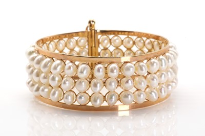 Lot 197 - A gold mounted three row cultured freshwater pearl bangle