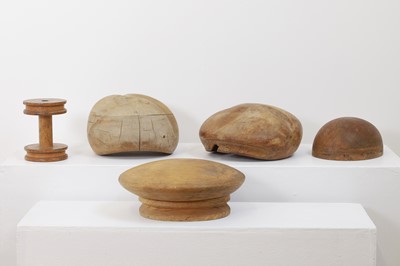 Lot 440 - A set of four fruitwood milliner's hat moulds
