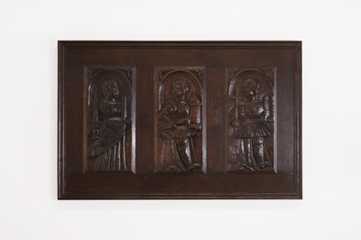 Lot 353 - Three carved oak panels depicting saints