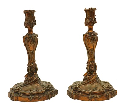 Lot 154 - A pair of gilt bronze candlesticks in the Louis XV style