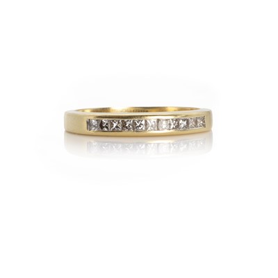 Lot 1083 - An 18ct gold diamond half eternity ring