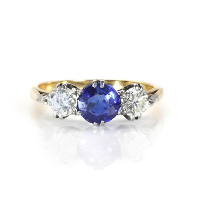 Lot 155 - An 18ct gold three stone diamond and sapphire ring