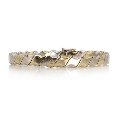 Lot 1102 - A 9ct two colour gold hinged bangle
