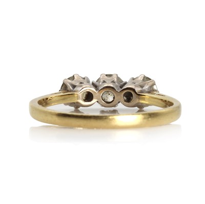 Lot 1067 - An 18ct gold diamond three stone ring