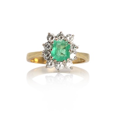 Lot 1143 - An 18ct gold emerald and diamond cluster ring