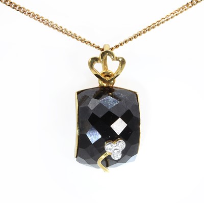 Lot 1186 - A gold onyx and diamond pendant