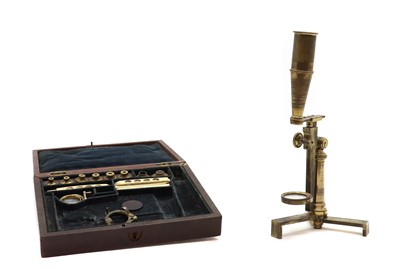 Lot 335 - A cased brass field microscope