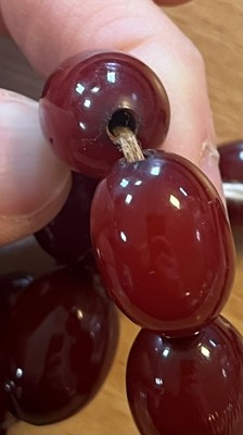 Lot 222 - A uniform single row Bakelite bead necklace