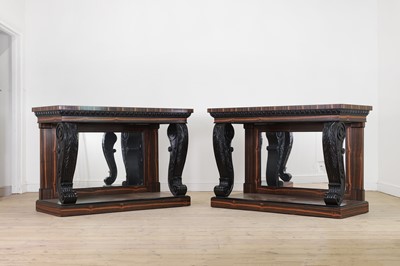 Lot 629 - A pair of Regency-style coromandel and ebonised pier tables