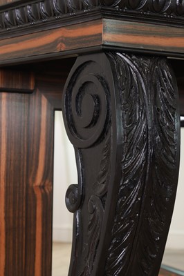 Lot 629 - A pair of Regency-style coromandel and ebonised pier tables